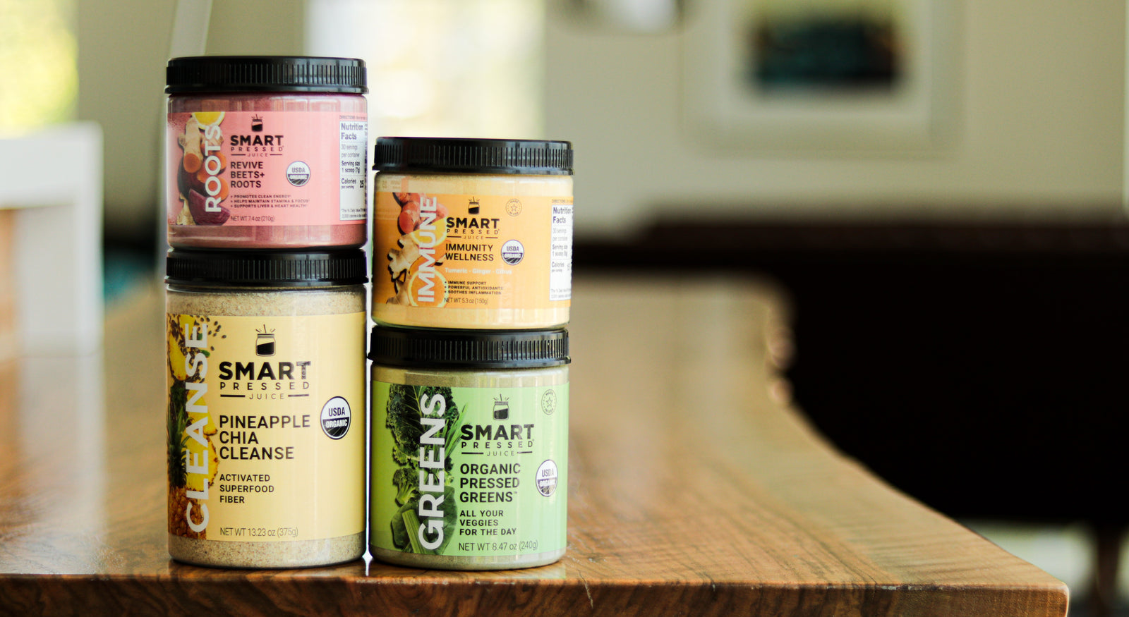 4 bottles of protein shake on top of a brown table